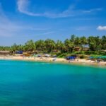 Golden beaches, swaying palm trees, colorful beach shacks, and crystal-clear Arabian Sea in Goa.