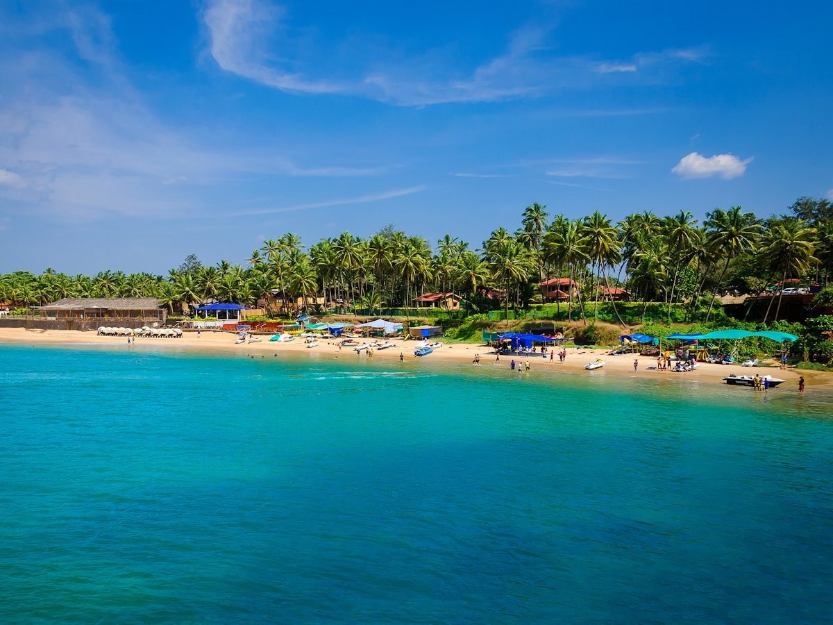 Golden beaches, swaying palm trees, colorful beach shacks, and crystal-clear Arabian Sea in Goa.
