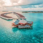 Crystal-clear turquoise waters and luxurious overwater villas in the Maldives.